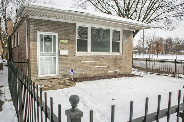 exterior space featuring brick siding and fence private yard