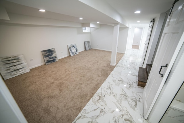 below grade area with baseboards, carpet flooring, and recessed lighting