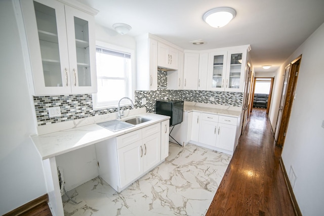 kitchen featuring glass insert cabinets, marble finish floor, white cabinets, and light stone countertops