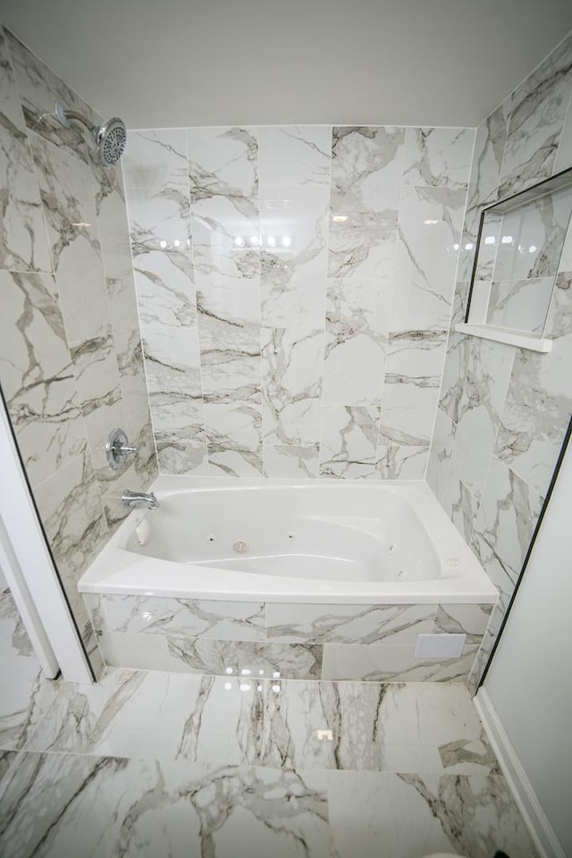 full bathroom featuring marble finish floor and a combined bath / shower with jetted tub