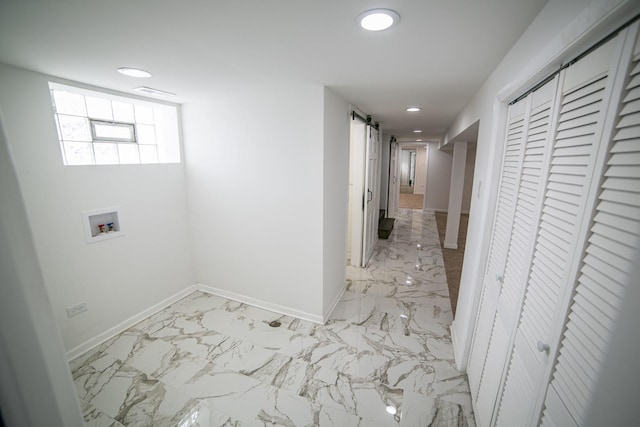 hallway with a barn door, recessed lighting, visible vents, baseboards, and marble finish floor