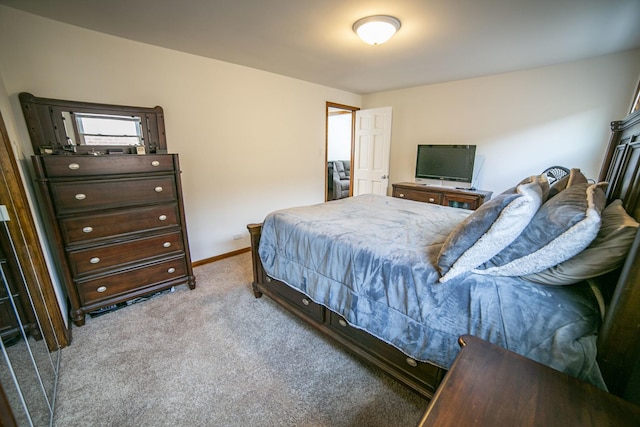 bedroom with baseboards and light colored carpet