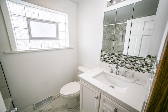 bathroom with a marble finish shower, visible vents, marble finish floor, vanity, and backsplash