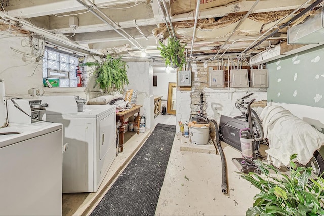 basement with electric panel and independent washer and dryer