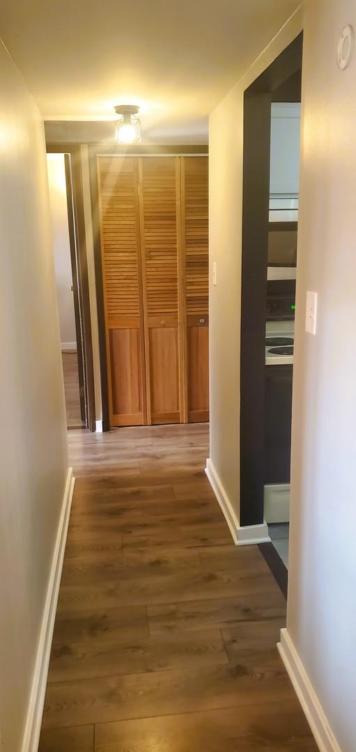 hallway with dark hardwood / wood-style flooring