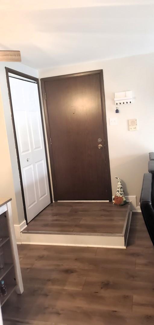 hallway with dark hardwood / wood-style flooring