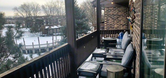 view of snow covered back of property