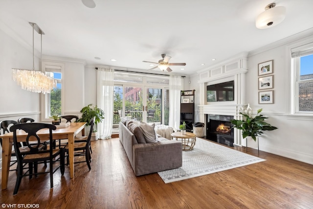 living room with ceiling fan, dark wood-type flooring, and a healthy amount of sunlight