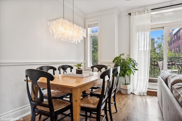 dining area with an inviting chandelier and hardwood / wood-style floors