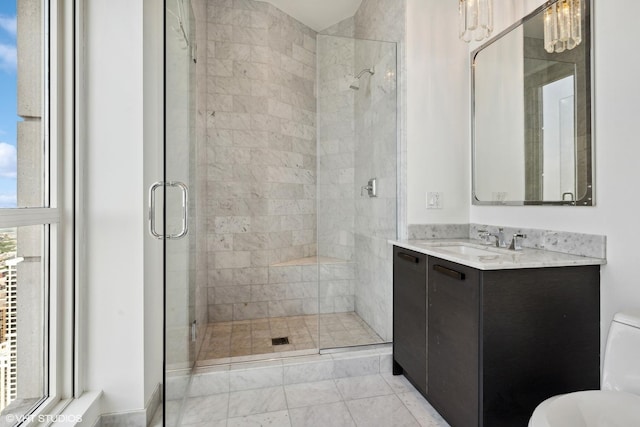 bathroom featuring a stall shower, vanity, and toilet