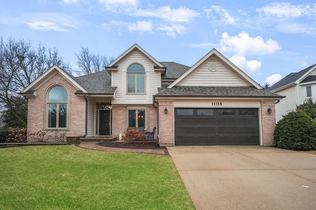 traditional-style house featuring brick siding, a shingled roof, a front yard, a garage, and driveway