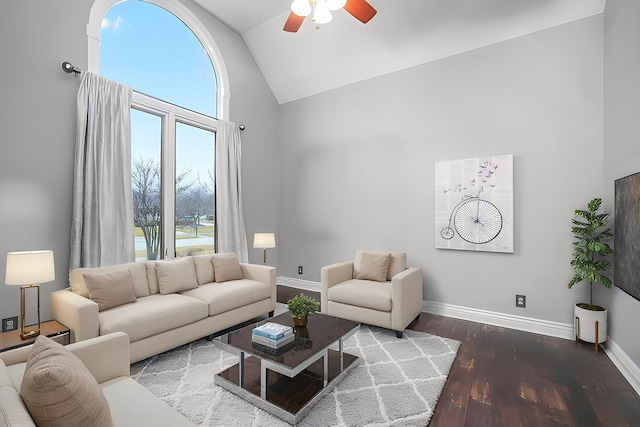 living room with ceiling fan, baseboards, and wood finished floors