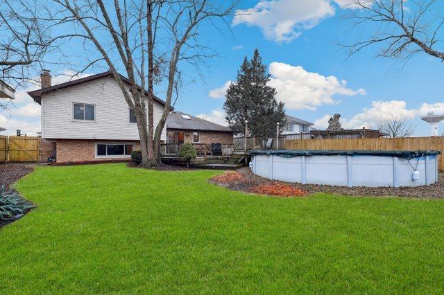 view of yard with a fenced in pool and fence