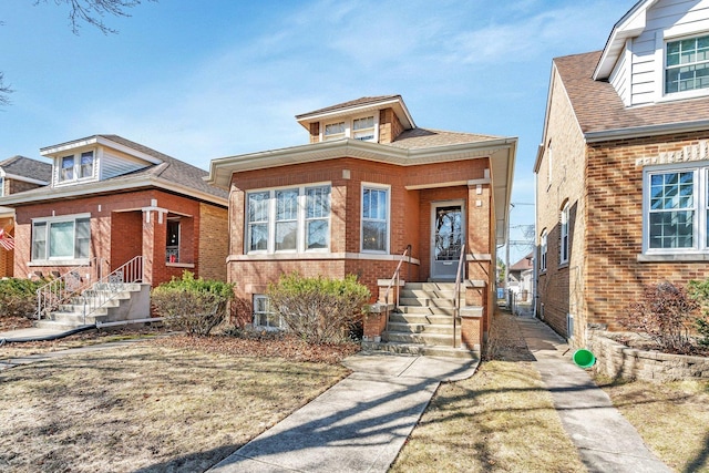 view of front of property with brick siding and roof with shingles