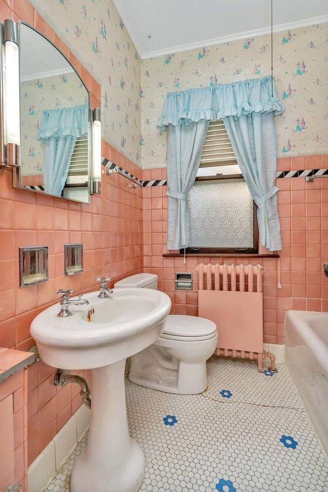 bathroom featuring wainscoting, ornamental molding, radiator heating unit, and wallpapered walls