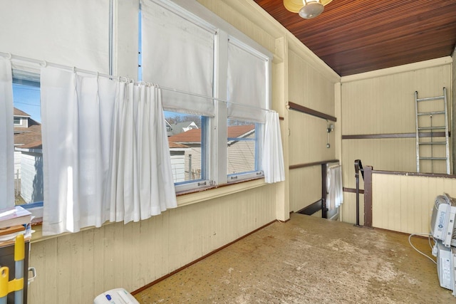 empty room with wooden ceiling and wooden walls