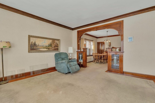 sitting room featuring baseboards, arched walkways, carpet, and an inviting chandelier