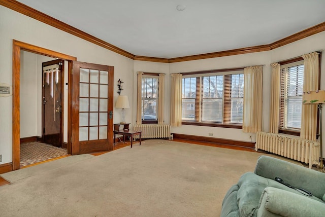 sitting room with carpet flooring, crown molding, and radiator heating unit