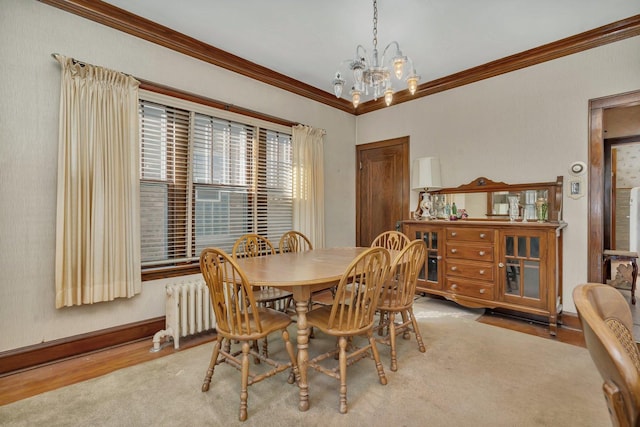 dining space with baseboards, an inviting chandelier, ornamental molding, and radiator heating unit