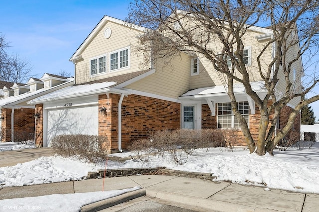 view of front of house featuring a garage and brick siding