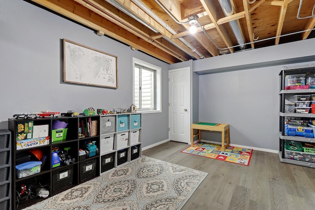 recreation room with hardwood / wood-style floors