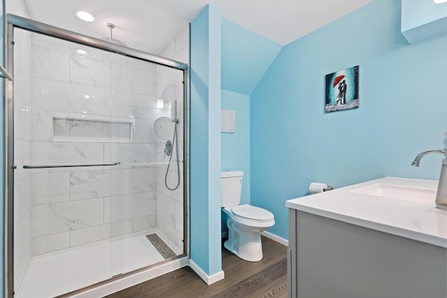 bathroom featuring hardwood / wood-style flooring, vanity, toilet, and a shower with shower door