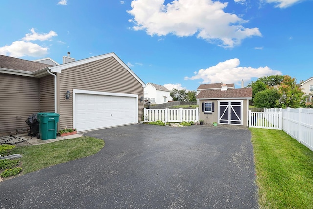 garage featuring a lawn