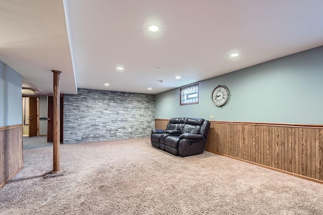 living area featuring wooden walls, light colored carpet, recessed lighting, and wainscoting