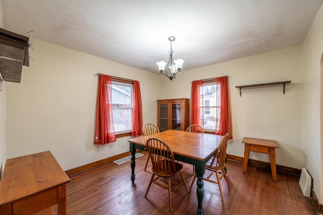 dining room featuring a chandelier and dark hardwood / wood-style floors