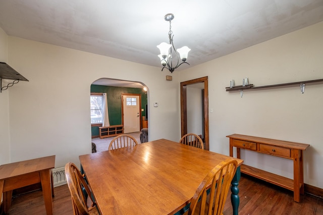 dining room featuring an inviting chandelier and dark hardwood / wood-style floors