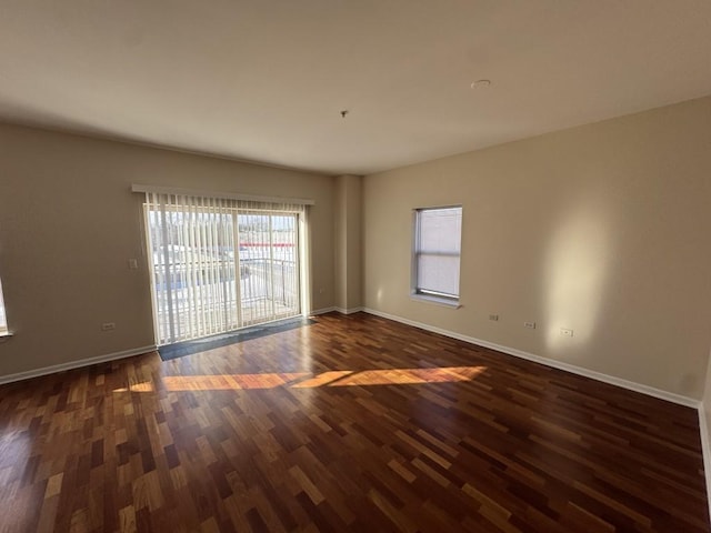 spare room with dark wood-type flooring