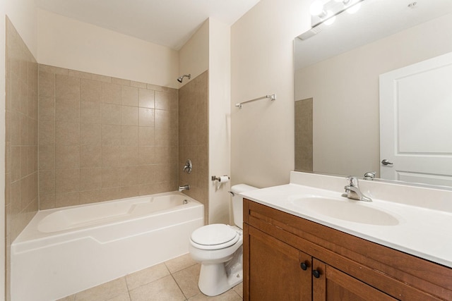 full bathroom featuring tile patterned floors, toilet, vanity, and tiled shower / bath combo