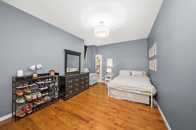 bedroom featuring baseboards and wood finished floors