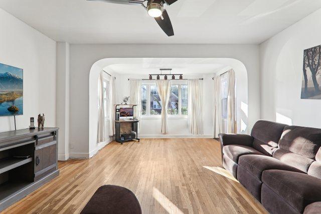 living room with light hardwood / wood-style floors and ceiling fan