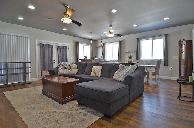 living area featuring baseboards, dark wood finished floors, a ceiling fan, and recessed lighting