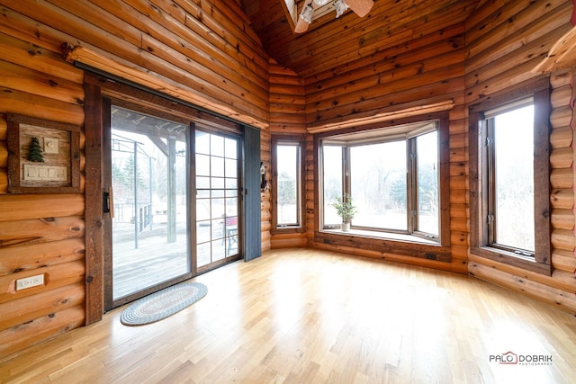 interior space with high vaulted ceiling, a wealth of natural light, and light wood finished floors