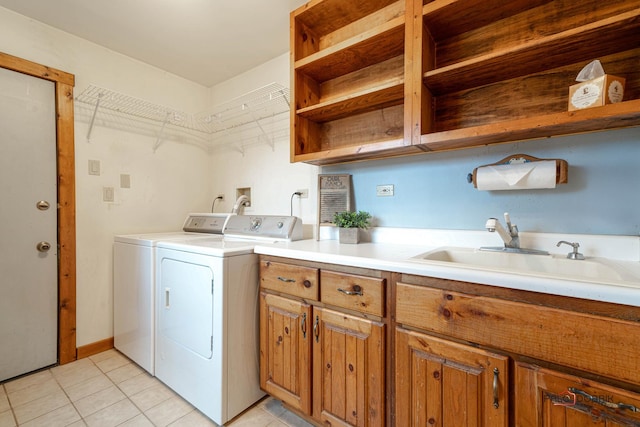 laundry room featuring cabinet space, washing machine and dryer, a sink, and light tile patterned flooring