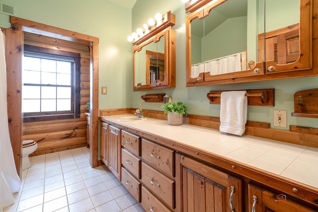 bathroom featuring lofted ceiling, toilet, visible vents, vanity, and tile patterned floors