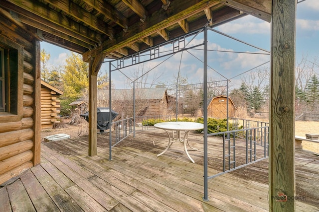 deck featuring an outdoor structure and a storage shed