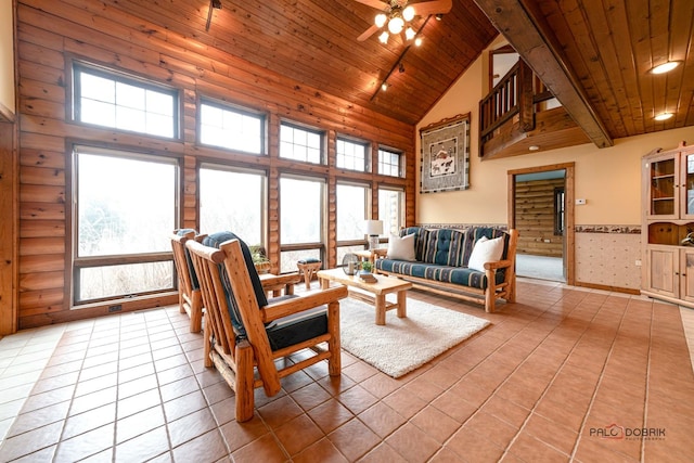 living area with wooden ceiling, high vaulted ceiling, beamed ceiling, and light tile patterned flooring