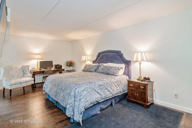 bedroom with dark hardwood / wood-style flooring