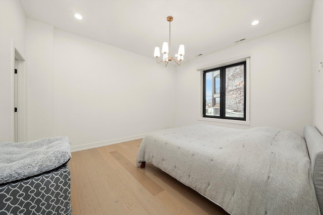 bedroom with recessed lighting, visible vents, an inviting chandelier, light wood-style floors, and baseboards