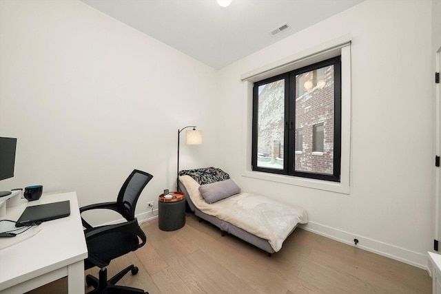 home office with visible vents, baseboards, and wood finished floors