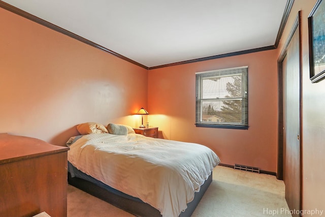 bedroom featuring ornamental molding and light carpet