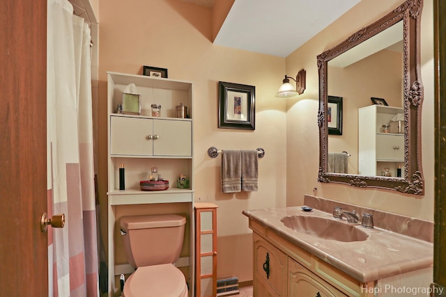 bathroom with toilet and vanity