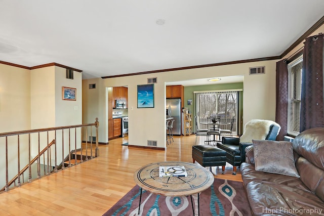 living room featuring light hardwood / wood-style flooring and crown molding