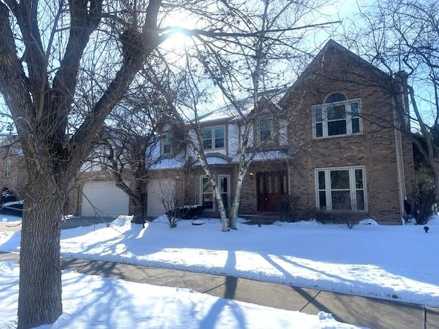 view of front of property featuring a garage and brick siding