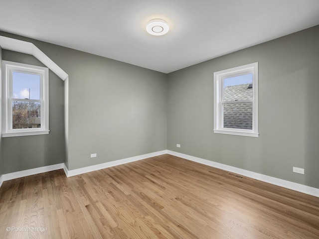 empty room with plenty of natural light and light wood-type flooring