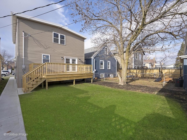 back of property featuring a yard and a wooden deck