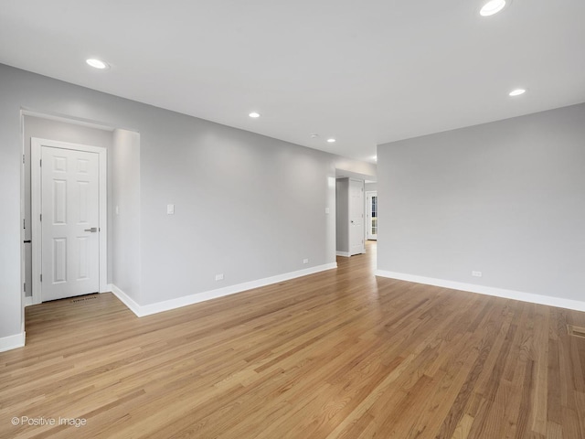 empty room with light hardwood / wood-style flooring